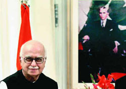 Advani in front of a portrait of MA Jinnah