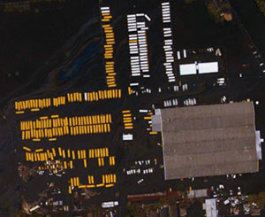 An aerial photograph of buses standing in a yard full of water