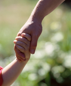 father holding hand of child